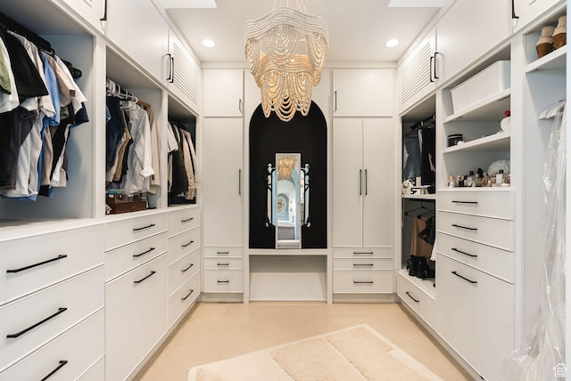 spacious closet with a chandelier
