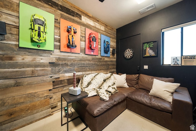 living room with wooden walls and visible vents