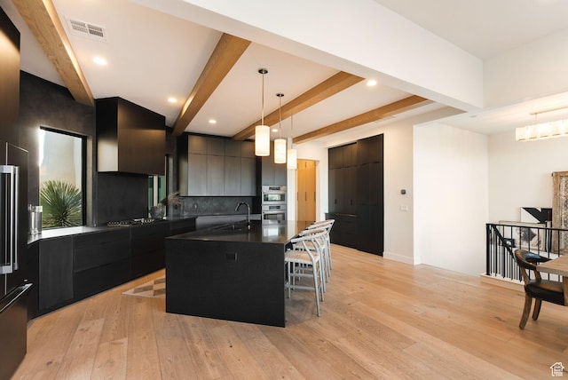 kitchen featuring light wood-style floors, dark countertops, and modern cabinets
