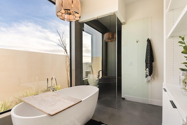 full bathroom featuring a freestanding tub and baseboards