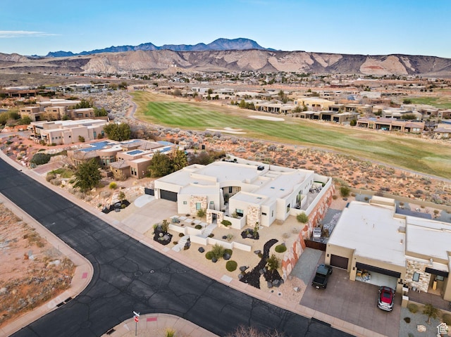 birds eye view of property with view of golf course, a mountain view, and a residential view