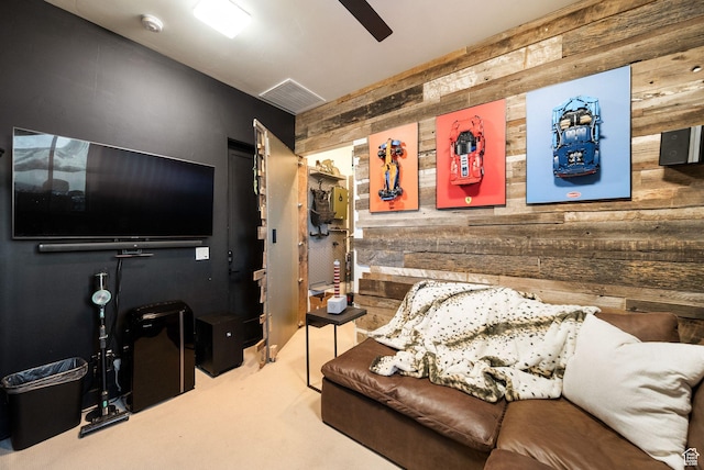 living room featuring wooden walls, carpet, and visible vents