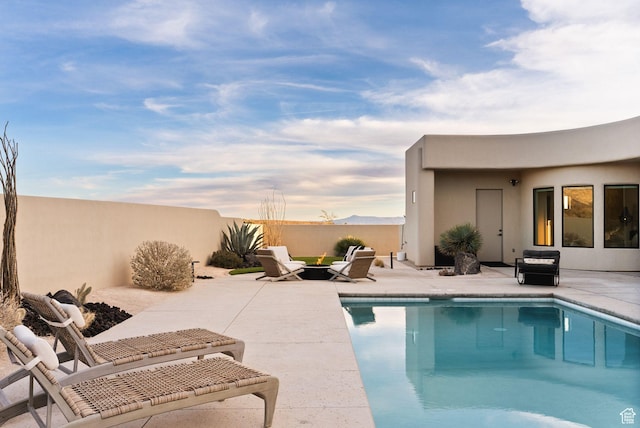 view of pool featuring a fenced in pool, fence, and a patio area
