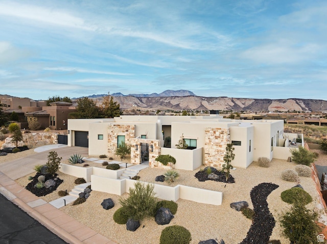 view of front of house with a mountain view, fence private yard, and concrete driveway