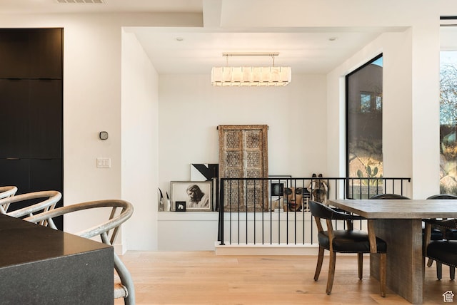 dining area with visible vents and wood finished floors