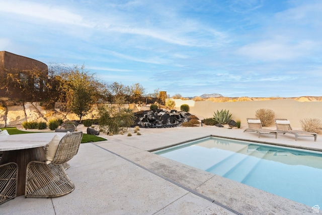 view of swimming pool with a patio and a fenced backyard
