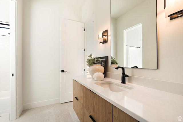 bathroom featuring tile patterned floors, baseboards, and vanity