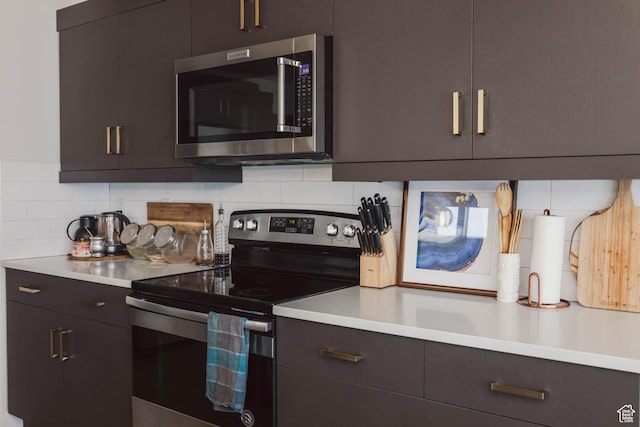 kitchen with backsplash, stainless steel appliances, and light countertops