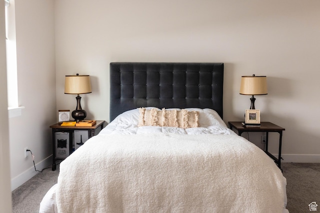 carpeted bedroom featuring baseboards