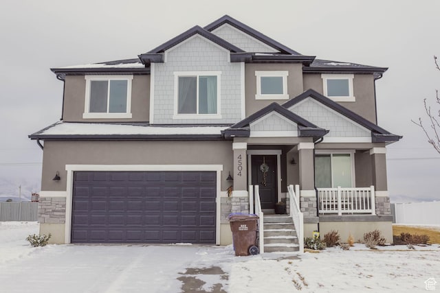 craftsman inspired home featuring covered porch, stucco siding, a garage, stone siding, and driveway