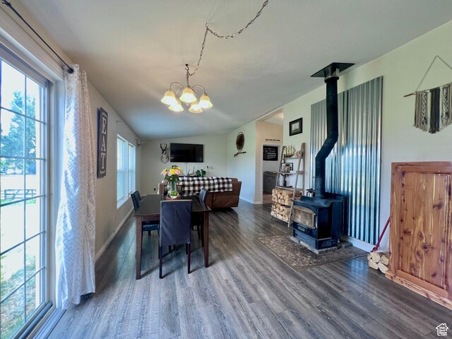 1568 N 750 E, Vernal, UT 84078 - dining space with wood finished floors, baseboards, a chandelier, a wood stove, and vaulted ceiling