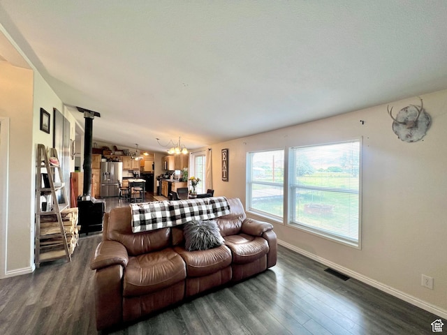 1568 N 750 E, Vernal, UT 84078 - living room featuring visible vents, dark wood-type flooring, a chandelier, and a wood stove