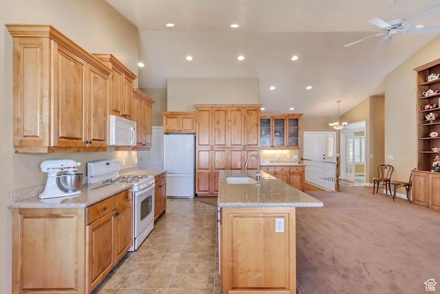 92 W Centerville Commons Way, Centerville, UT 84014 - kitchen featuring ceiling fan, light stone countertops, an island with sink, white appliances, and a sink