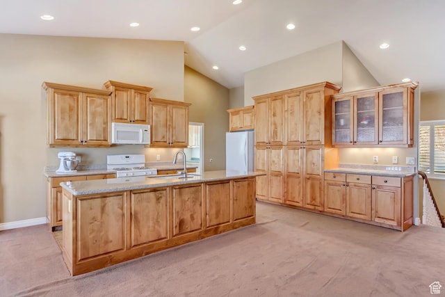 92 W Centerville Commons Way, Centerville, UT 84014 - kitchen with white appliances, light brown cabinets, a kitchen island with sink, a sink, and light colored carpet