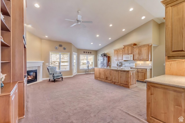 92 W Centerville Commons Way, Centerville, UT 84014 - kitchen featuring light carpet, a center island with sink, open floor plan, white microwave, and ceiling fan
