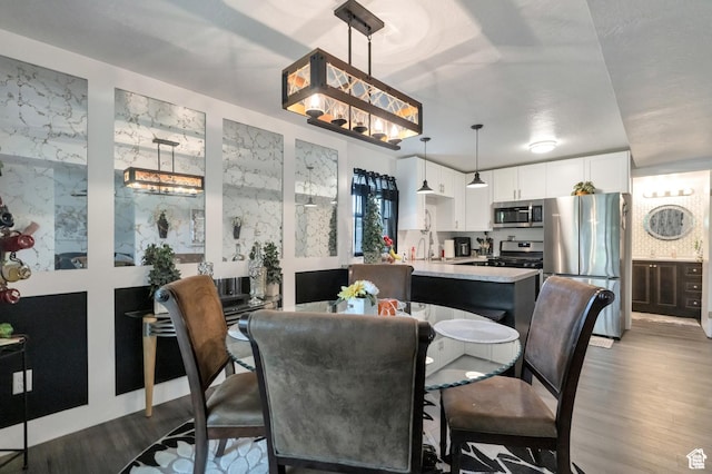 1333 S Lorl Ln E Unit 6, Ogden, UT 84404 - dining area with an inviting chandelier and wood finished floors