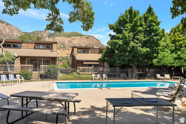 1333 S Lorl Ln E Unit 6, Ogden, UT 84404 - pool featuring a mountain view, a patio, and fence
