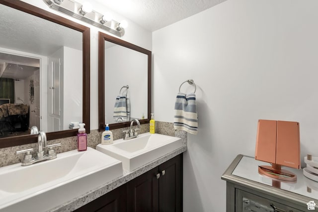 1333 S Lorl Ln E Unit 6, Ogden, UT 84404 - bathroom featuring a textured ceiling and vanity