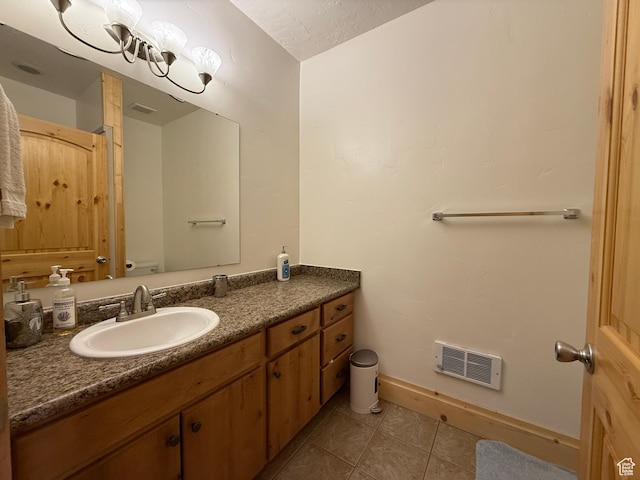 8043 E Badger Dr N, Heber City, UT 84032 - bathroom featuring tile patterned flooring, toilet, vanity, and baseboards