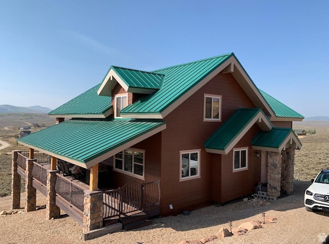 exterior space with a standing seam roof, a mountain view, and metal roof