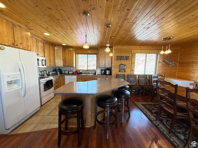 8043 E Badger Dr N, Heber City, UT 84032 - kitchen with white appliances, a sink, wooden ceiling, wood finished floors, and wooden walls