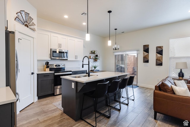 560 N Ventura Ln, Washington, UT 84780 - kitchen with light wood-type flooring, stainless steel appliances, light countertops, and a sink