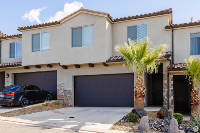 560 N Ventura Ln, Washington, UT 84780 - mediterranean / spanish house with stucco siding, driveway, stone siding, a garage, and a tiled roof