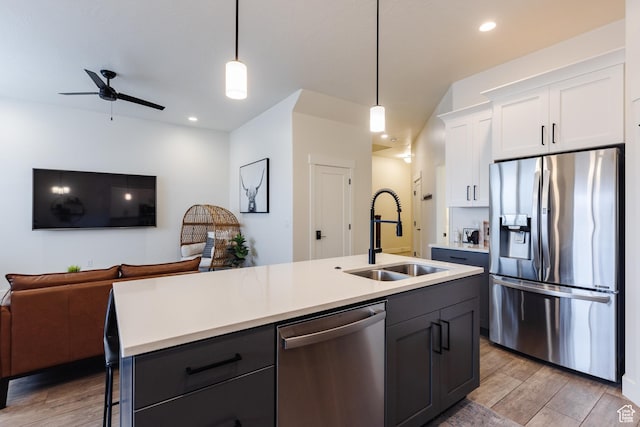 560 N Ventura Ln, Washington, UT 84780 - kitchen with light wood-style floors, open floor plan, appliances with stainless steel finishes, and a sink