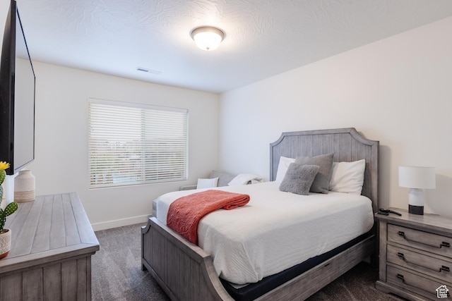560 N Ventura Ln, Washington, UT 84780 - bedroom with visible vents, dark carpet, and baseboards
