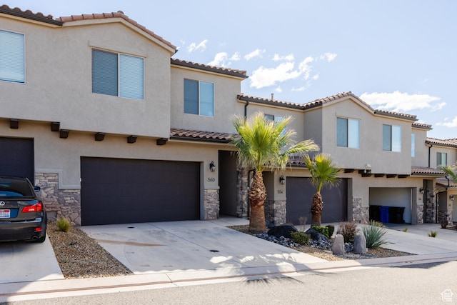 560 N Ventura Ln, Washington, UT 84780 - mediterranean / spanish house with a tiled roof, concrete driveway, stucco siding, a garage, and stone siding