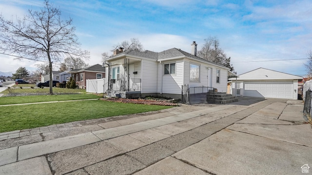 5460 S 4360 W, Kearns, UT 84118 - view of front of home featuring fence, a chimney, an outdoor structure, a front lawn, and a detached garage