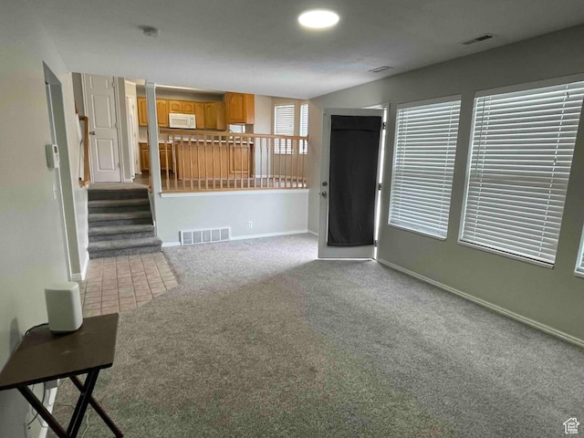 1217 E 3025 N, Layton, UT 84040 - unfurnished living room with visible vents, baseboards, and carpet