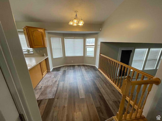 1217 E 3025 N, Layton, UT 84040 - unfurnished dining area featuring an inviting chandelier, dark wood-style floors, and baseboards
