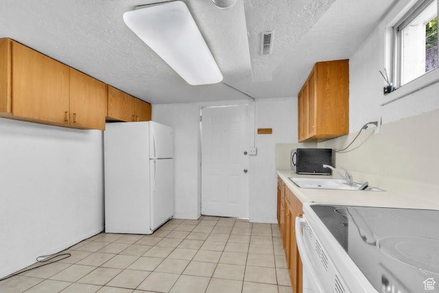 770 W 700 N, Provo, UT 84601 - kitchen featuring white appliances, a sink, light countertops, a textured ceiling, and light tile patterned floors