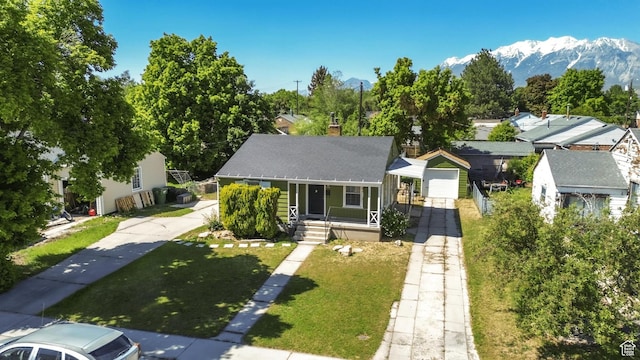 770 W 700 N, Provo, UT 84601 - view of front of home with covered porch, a chimney, a front lawn, a mountain view, and a shingled roof