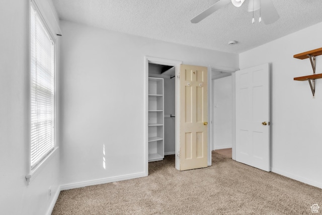 770 W 700 N, Provo, UT 84601 - unfurnished bedroom with carpet, a spacious closet, a textured ceiling, ceiling fan, and baseboards
