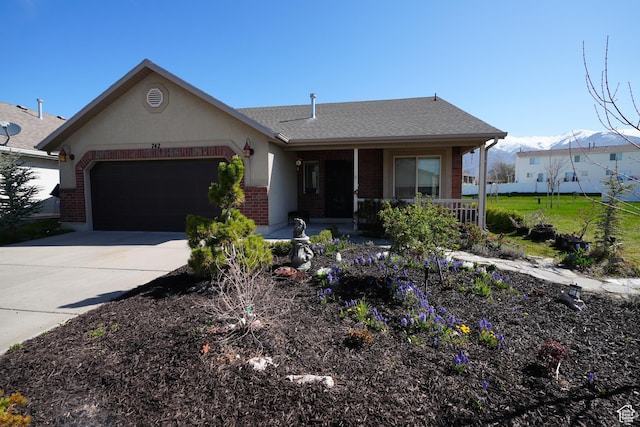 742 N Stonne Ln, Kaysville, UT 84037 - view of front facade with a porch, an attached garage, brick siding, driveway, and roof with shingles