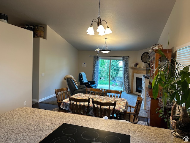 742 N Stonne Ln, Kaysville, UT 84037 - carpeted dining space featuring a chandelier and a glass covered fireplace