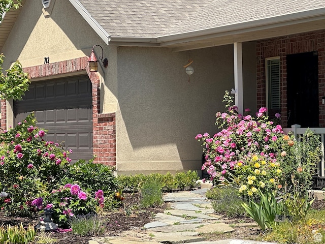 742 N Stonne Ln, Kaysville, UT 84037 - view of side of property with stucco siding, a shingled roof, an attached garage, and brick siding