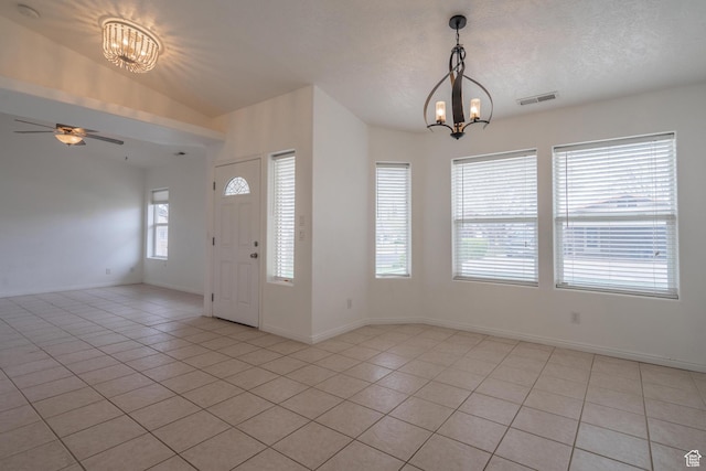 2163 W 127 S, Hurricane, UT 84737 - foyer entrance featuring light tile patterned floors, baseboards, vaulted ceiling, and ceiling fan with notable chandelier