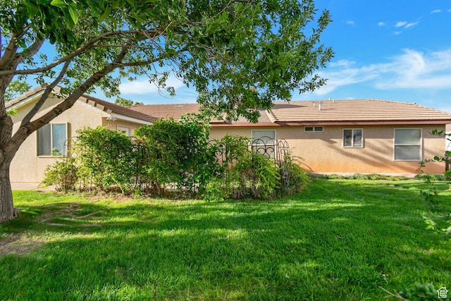 2163 W 127 S, Hurricane, UT 84737 - rear view of house featuring a lawn, a tile roof, and stucco siding