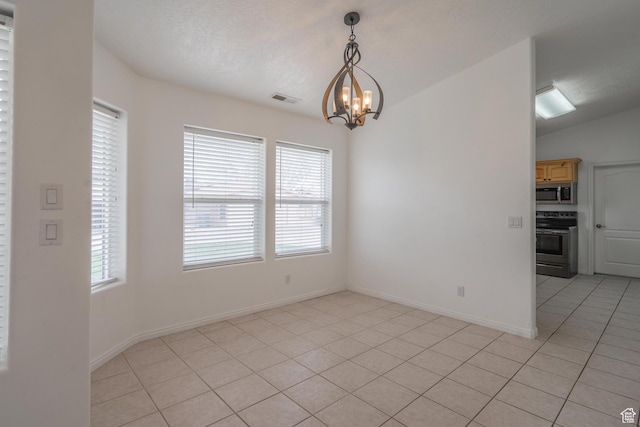 2163 W 127 S, Hurricane, UT 84737 - unfurnished room with a notable chandelier, lofted ceiling, light tile patterned floors, baseboards, and visible vents