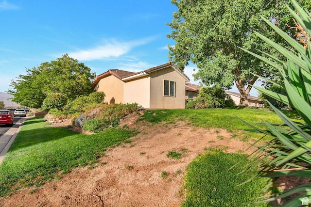 2163 W 127 S, Hurricane, UT 84737 - view of property exterior featuring a tiled roof, stucco siding, and a lawn