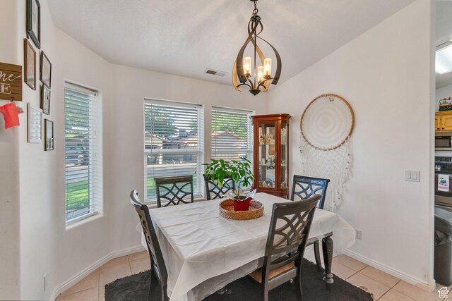 2163 W 127 S, Hurricane, UT 84737 - dining area with baseboards, a notable chandelier, visible vents, and light tile patterned floors