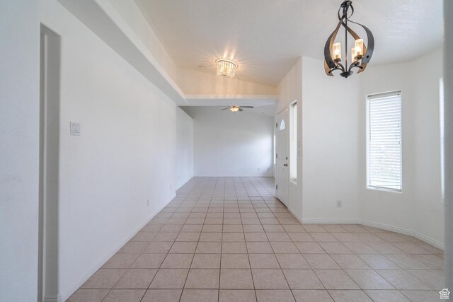 2163 W 127 S, Hurricane, UT 84737 - spare room featuring light tile patterned floors, lofted ceiling, baseboards, and ceiling fan with notable chandelier