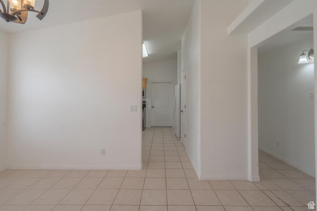 2163 W 127 S, Hurricane, UT 84737 - empty room featuring an inviting chandelier, light tile patterned floors, baseboards, and vaulted ceiling
