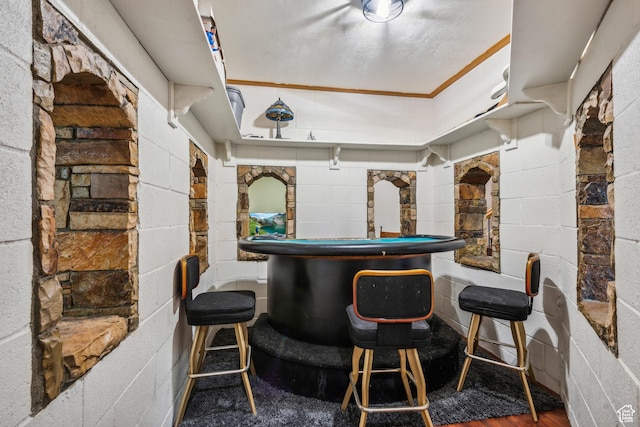 bar featuring concrete block wall