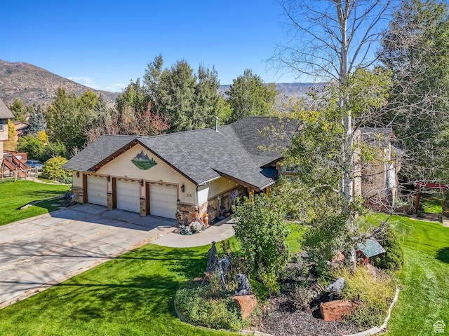 view of front of house with driveway, an attached garage, stucco siding, a front lawn, and stone siding