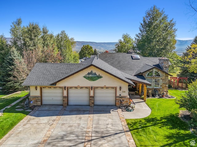 view of front of property featuring a front lawn, a garage, stone siding, and a shingled roof