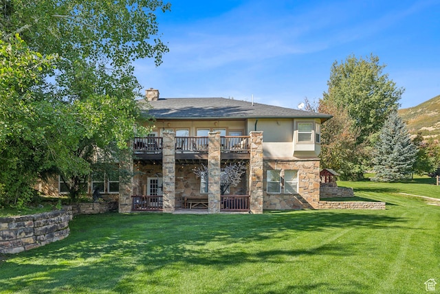back of property featuring a yard, a chimney, stucco siding, stone siding, and a patio area